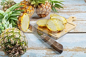 .Fresh pineapple fruit sliced Ã¢â¬â¹Ã¢â¬â¹on a wooden cutting board